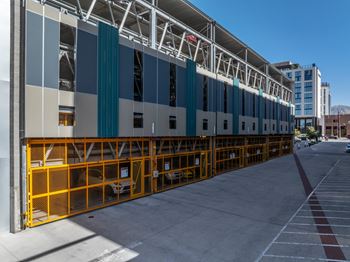A long row of parking garage doors are open.